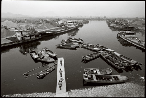 Militiamen patrol the dock of Chi Mei Village on the bank of Shenzhen River. [Photographed in 1993] 